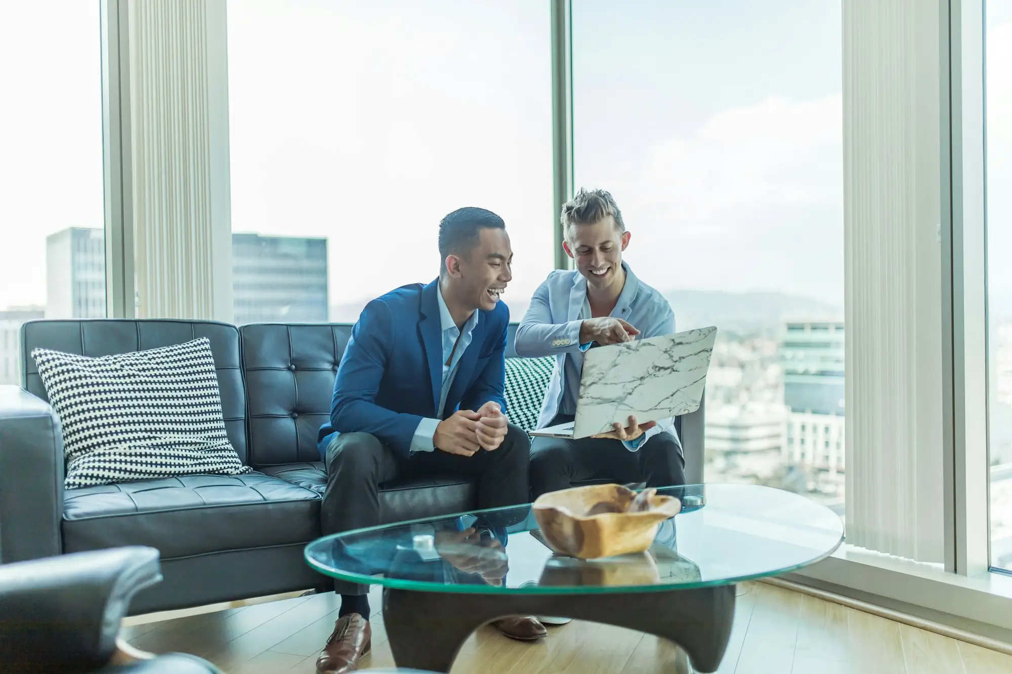 Business owner and accountant reviewing financial paperwork together at an office desk in Perth