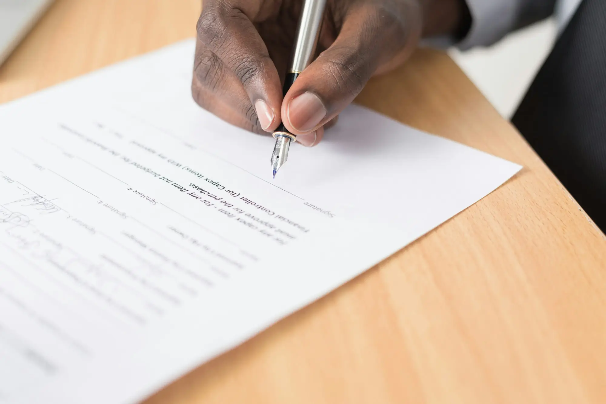Business owner reading a printed document carefully with a pen in hand