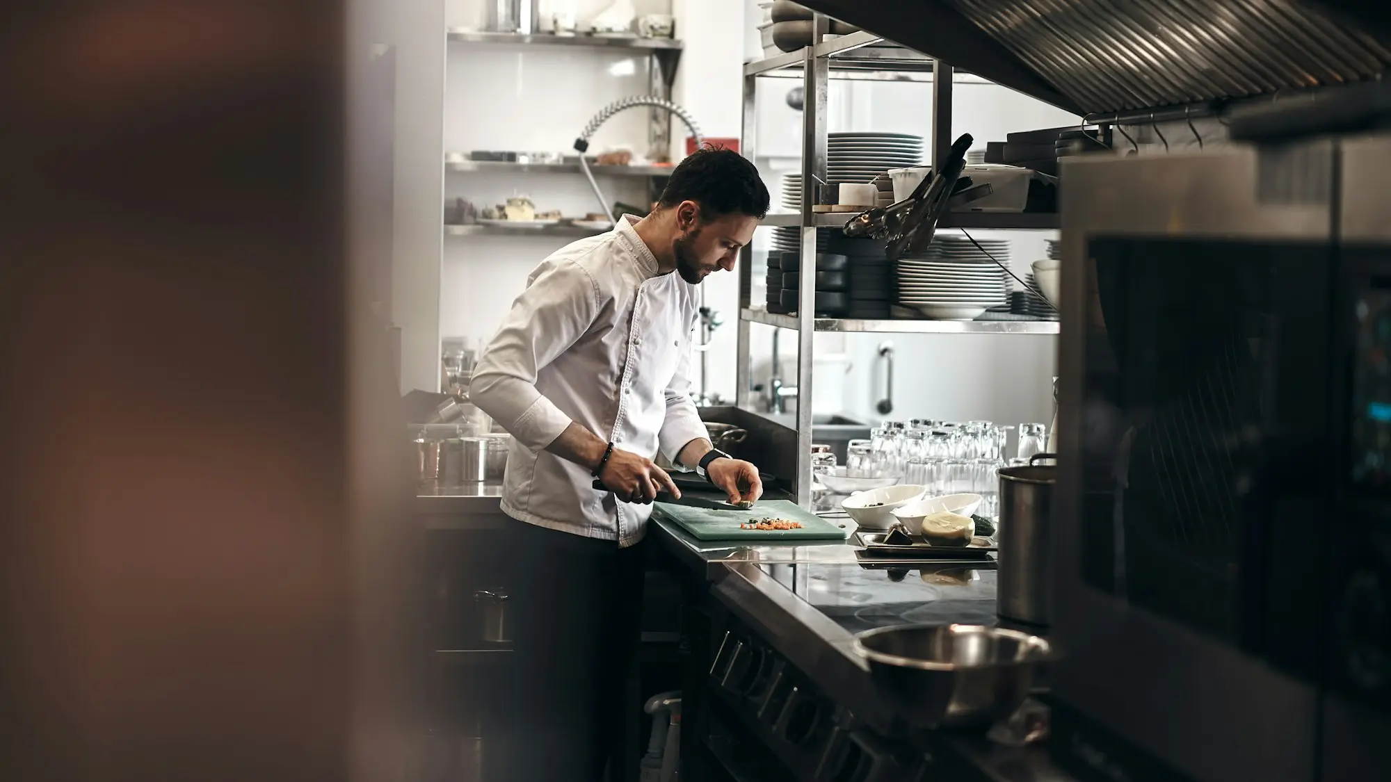 Restaurant kitchen team preparing dishes during a busy service