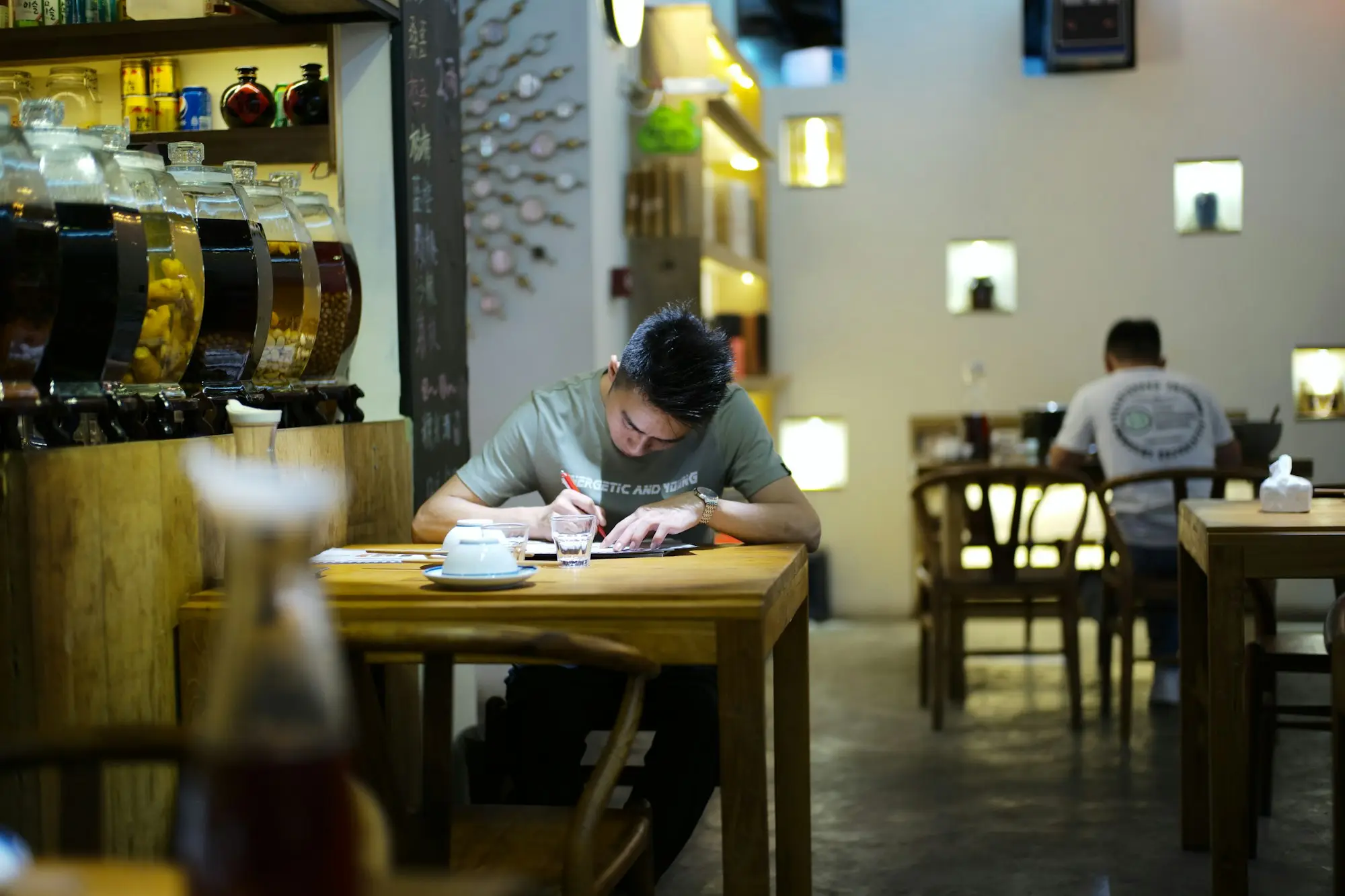 Business owner opening an official letter at a kitchen table with a laptop nearby
