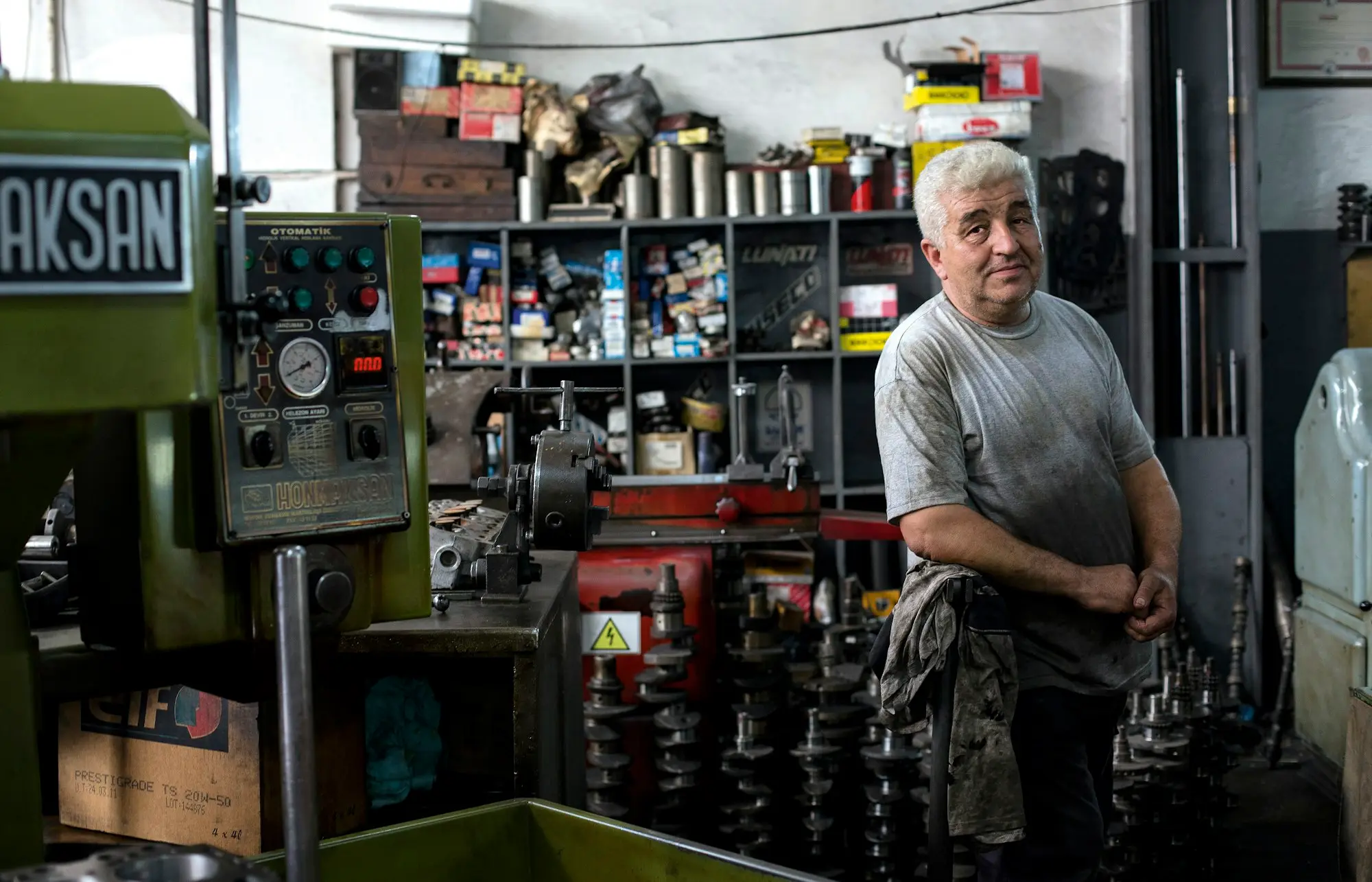 Engineer operating a lathe in a small manufacturing workshop in Geelong